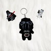 Darth vader plush key ring placed along side lego minifigures of storm trooper and darth vader against a white fur ackground