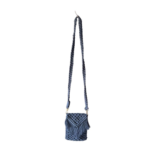 Macrame grey small bag with a long handle placed against a grey background