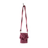 Maroon macrame small bag with a long handle placed against a grey background