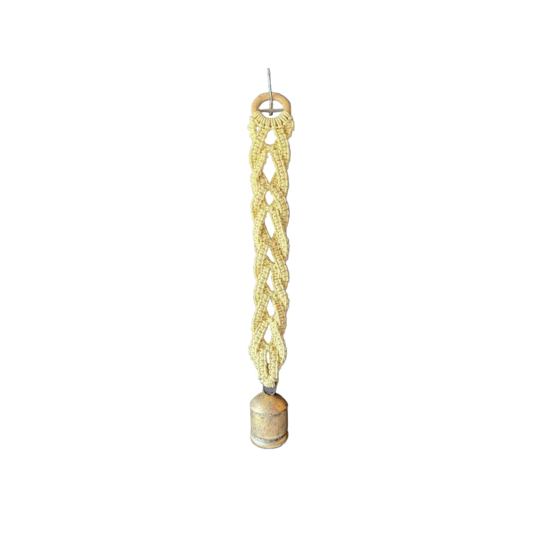 Yellow macrame wall hanging with a swiss bell