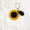 crochet sunflower keyring placed on a white fur background