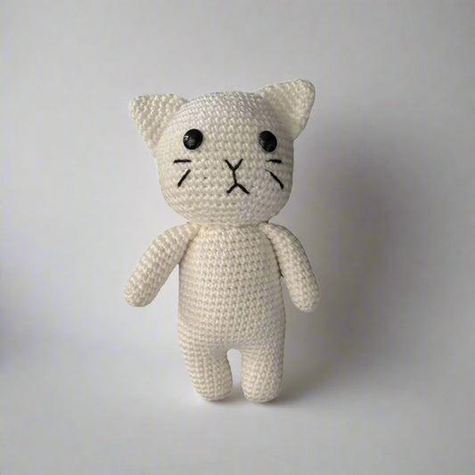 Crochet plush cat placed against a white background