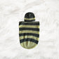 Yellow with grey stripes Crochet baby cocoon with a baby beanie placed on a white fur fabric