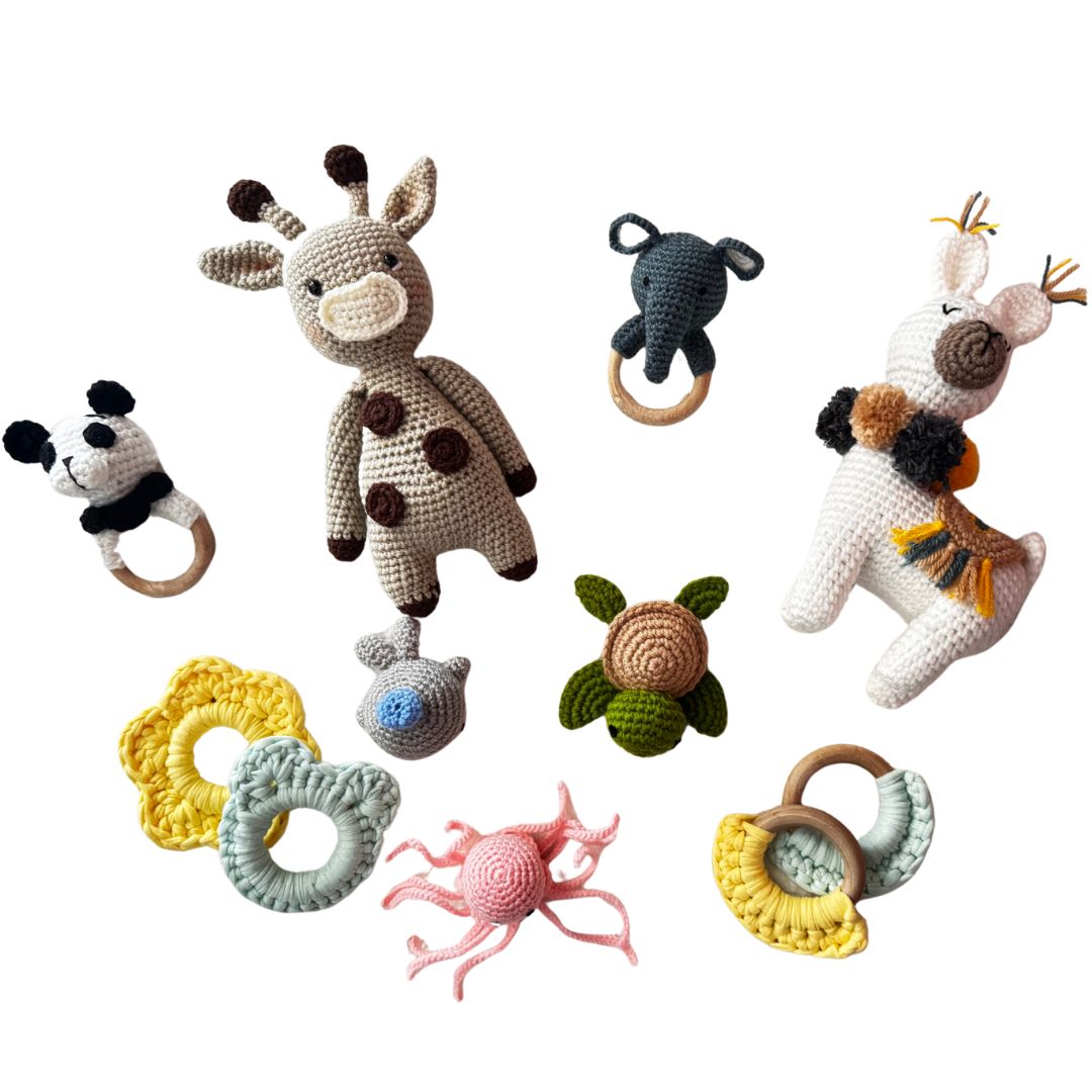 Collection of crochet plushies and teethers on a white background