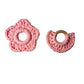 Two pink crochet wooden teethers on a white background