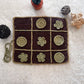 Crocheted tic-tac-toe board with flower patterns on a textured surface.