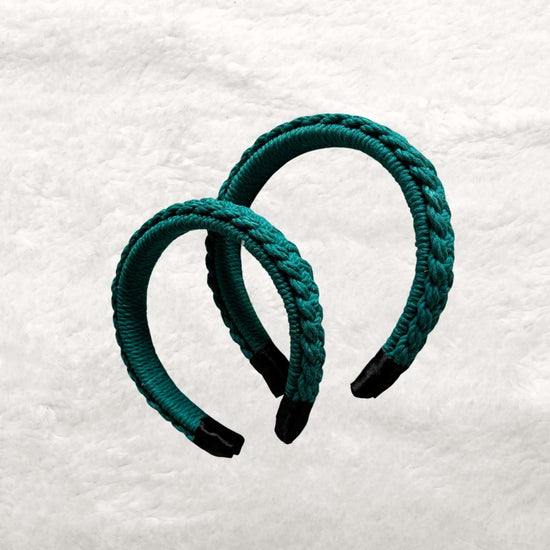 Two macrame headbands in teal blue placed next to each other against a white background 