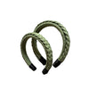 Two green macrame hairbands on a white background