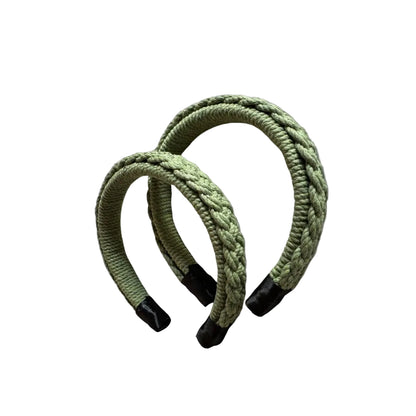 Two green macrame hairbands on a white background