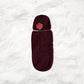 Maroon Crochet baby cocoon with a baby beanie placed on a white fur fabric