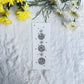 Mandala and floral sketch in black and white on a bookmark placed on fur fabric with fresh flowers in the background 
