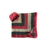 A striped crochet baby blanket with soft cream, rich grey, and warm pink colors, adorned with tiny crocheted flowers and a baby beanie placed on a white background